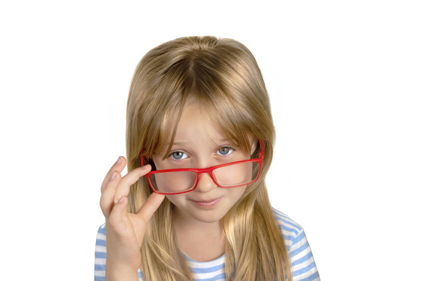 Beautiful blonde girl 8 years old in glasses on white background - Fotó, kép