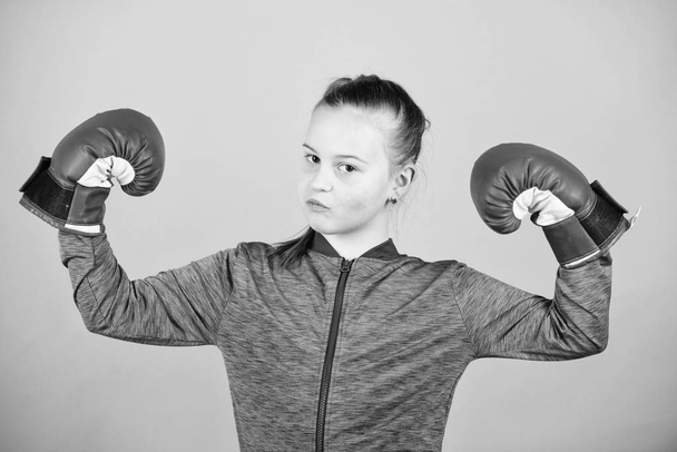 Female boxer. Sport upbringing. Boxing provide strict discipline. Girl cute boxer on blue background. With great power comes great responsibility. Contrary to stereotype. Boxer child in boxing gloves - Fotó, kép