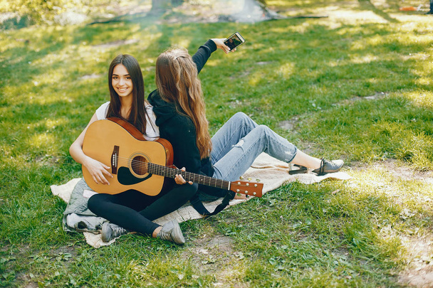 Two girls with a guitar - Фото, зображення