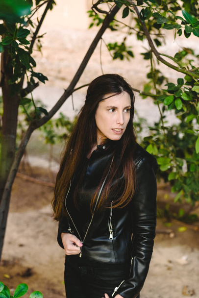 Model woman smiling at camera with black leather jacket, urban b - Photo, Image