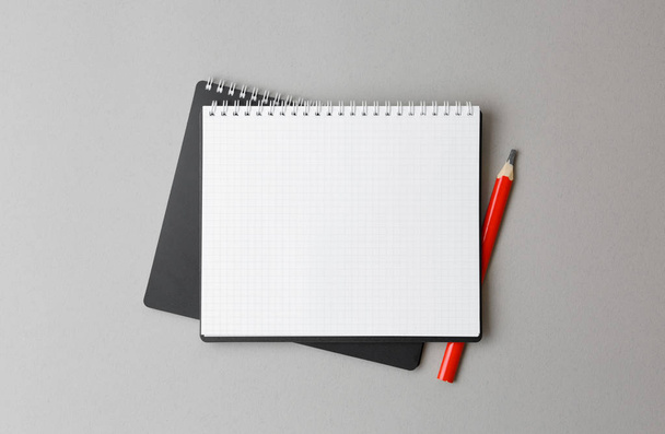 top view of a open black notebook with pencil on a gray background - Fotó, kép