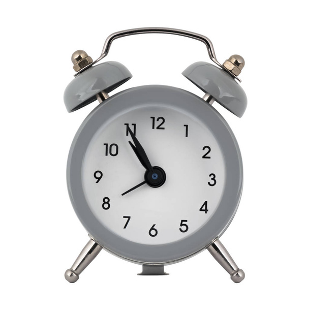 A gray clock with an alarm clock on a white background with arrows showing the time ten hours fifty five minutes or twenty two hours fifty five minutes - Photo, Image