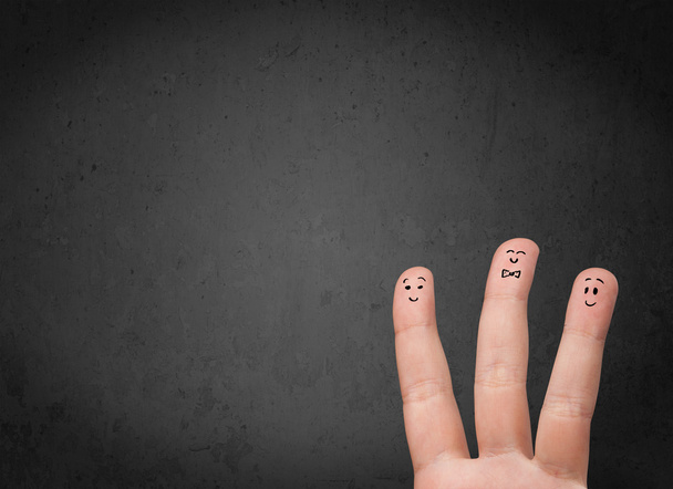 Happy finger smileys with empty copy space dark background - Photo, Image