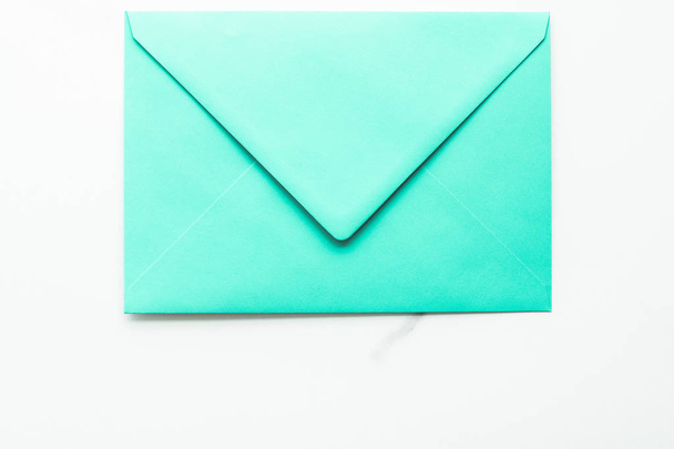 Blank paper envelopes on marble flatlay background, holiday mail - Фото, изображение