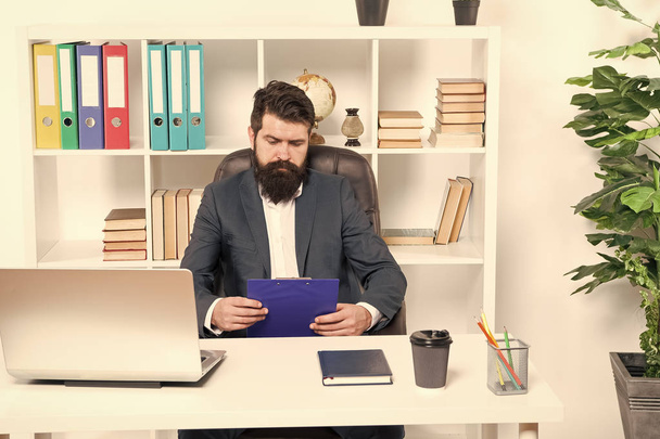 Check list. Man bearded hipster boss sit in leather armchair office interior. Boss at workplace. Manager formal clothing corporate style working. Business people concept. Busy boss in office - Fotoğraf, Görsel