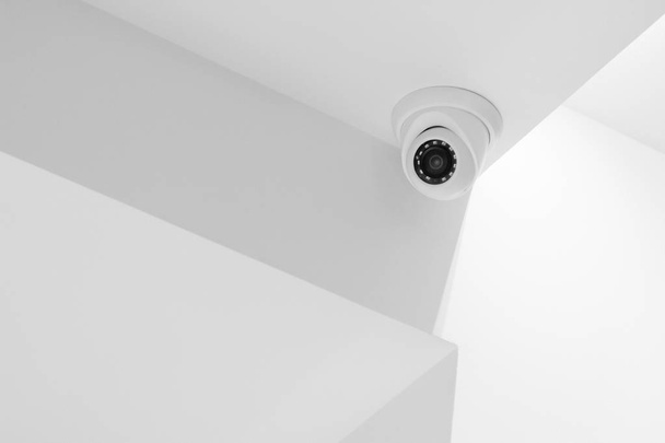 Security camera on a white wall. - Фото, изображение