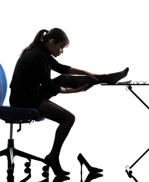 business woman massaging her leg silhouette - Foto, imagen
