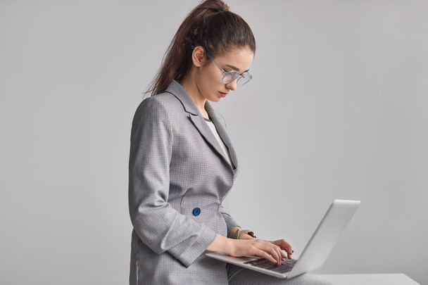 Young employee using laptop - Foto, imagen