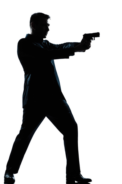 silhouette man full length shooting with gun - Foto, imagen