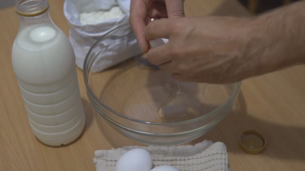 Breaking egg for pancake dough. - Кадри, відео