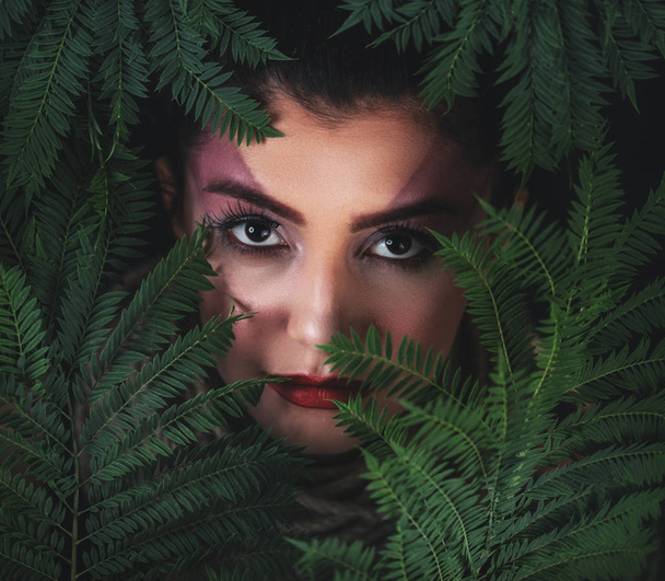 Portrait of young woman with green leaves background. Beauty concept. - Foto, Bild
