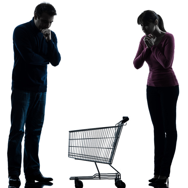 Couple woman man sad with empty shopping cart silhouette - Foto, afbeelding