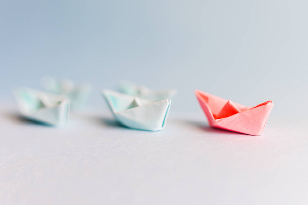 several blue and one red paper boat. The concept of leader, succ - Photo, Image