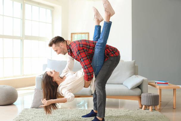 Happy young couple dancing at home - Foto, imagen