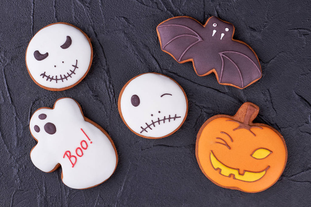 Colorful Halloween cookies on black slate. - Fotografie, Obrázek