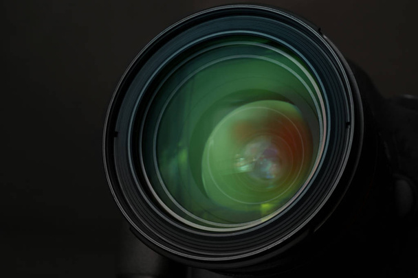 Lens of professional camera on black background, closeup - Фото, изображение