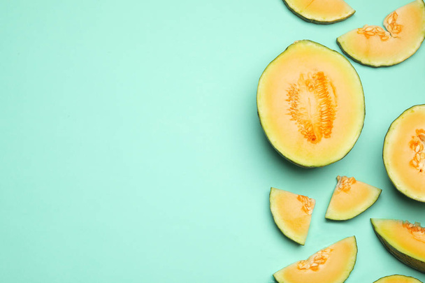 Flat lay composition with tasty melon on turquoise background, space for text - Fotó, kép