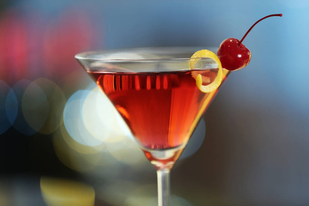 Glass of fresh alcoholic cocktail against blurred background - 写真・画像