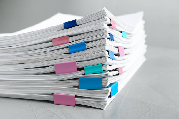 Stack of documents with binder clips on light table, closeup - Photo, Image