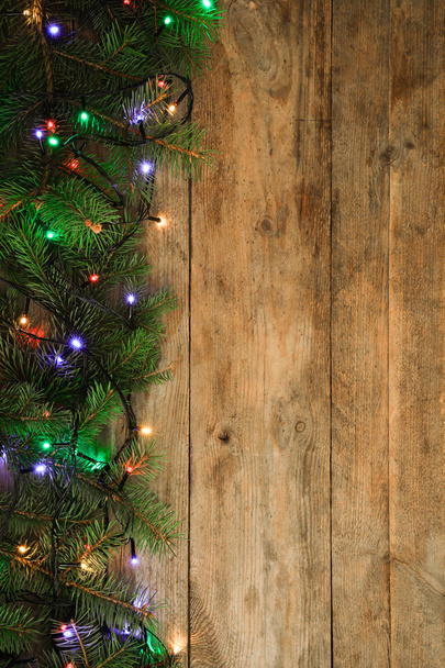 Fir tree branches with Christmas decoration on wooden background, flat lay. Space for text - Photo, Image