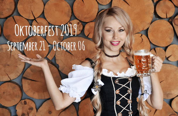 Oktoberfest woman with glass of beer posing outdoors. - Foto, immagini