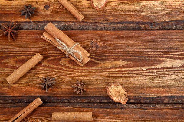 cinnamon on dark wooden background with space for text . top vie - Foto, Imagen