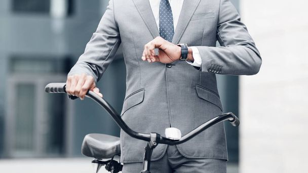 Confident businessman looking at his watch, going to work - Photo, Image