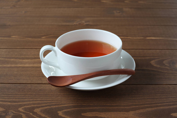 cup of tea closeup isolated on wooden table - Photo, Image