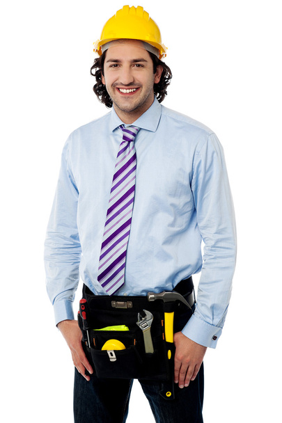 Smiling male architect wearing tool belt - Valokuva, kuva