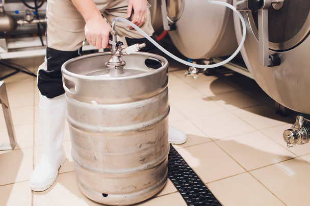Craft beer brewing equipment in brewery Metal tanks, alcoholic drink production. - Fotó, kép