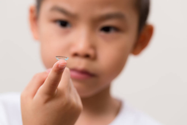Asian little boy hold a contact lens - Foto, Imagem