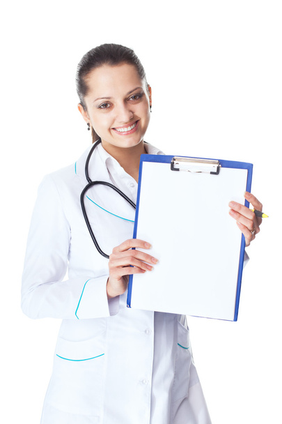 young smiling female doctor showing blank clipboard - Photo, Image