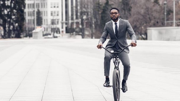 Businessman riding on bicycle to office, free space - Photo, Image