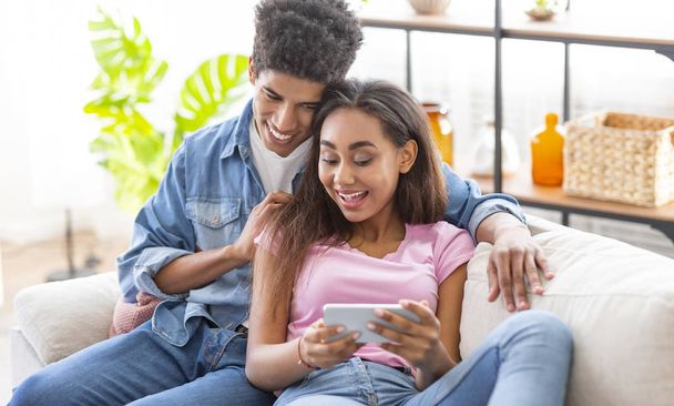 African american teens watching videos online on smartphone - Valokuva, kuva