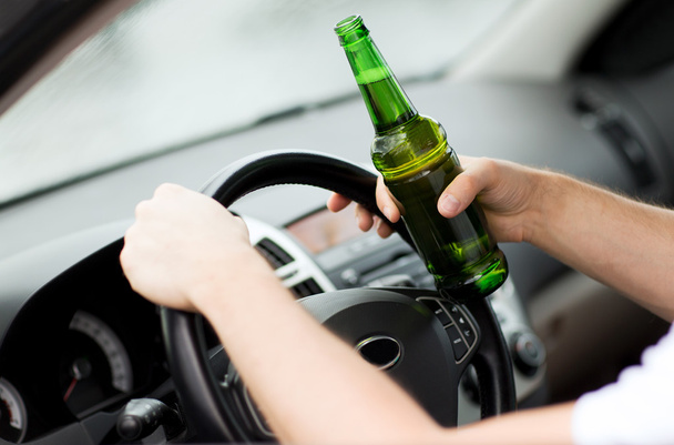 Man drinking alcohol while driving the car - Fotoğraf, Görsel