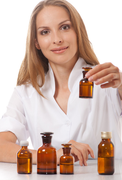 Woman doctor with medication in glass bottles - Фото, изображение
