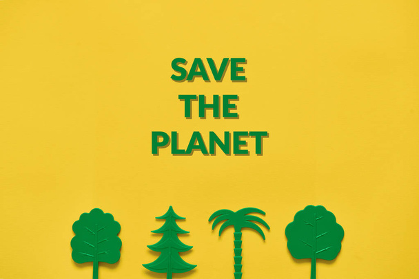 Green trees on yellow background. Nature ecology flat lay. Copy space - Foto, Imagen