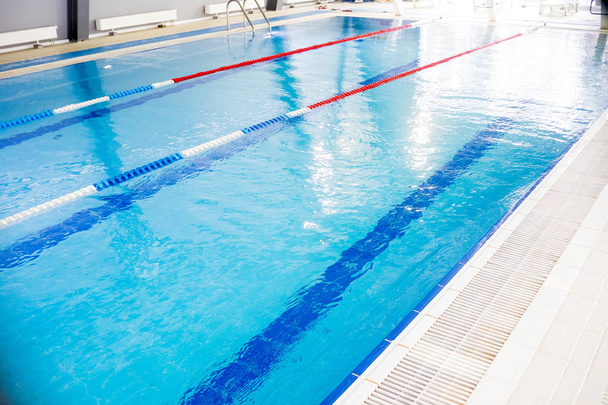 Indoor swimming pool, healthy concept.swiming pool for competition.pool with swim lanes. sport and enjoyment. Relaxation,recreation and sports training - Foto, afbeelding