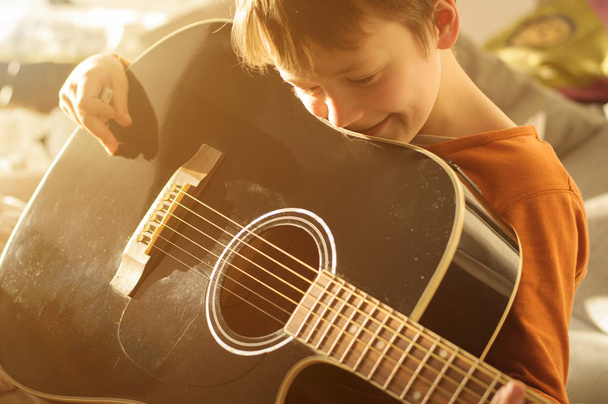 child with black acoustic guitar - Foto, imagen