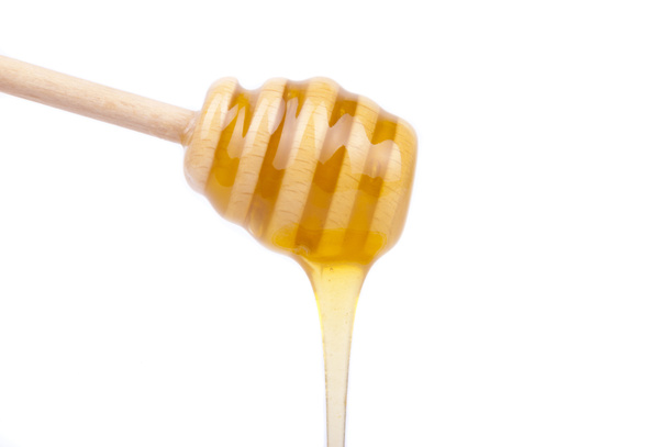 Miel goteando de una cuchara para miel
. - Foto, Imagen