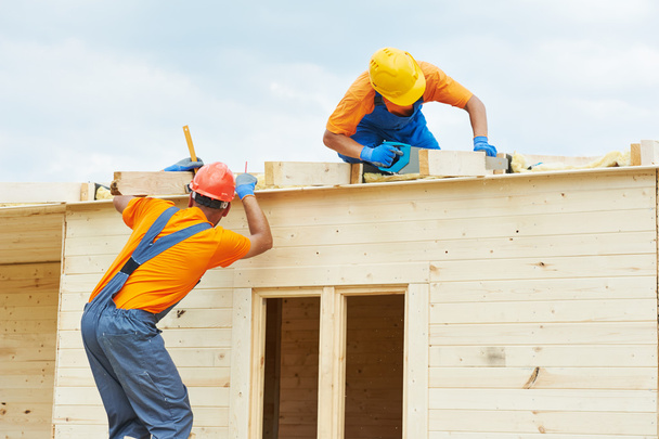 Carpenters at wooden roof work - Фото, изображение