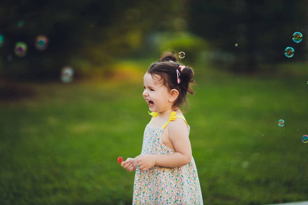 The image of a cute little girl with bubbles. - Foto, immagini