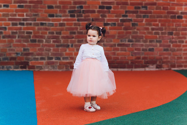 cute toddler girl in ballerina costume at beautiful summer garden. - Фото, изображение