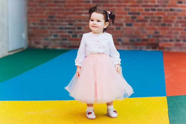 cute toddler girl in ballerina costume at beautiful summer garden. - Zdjęcie, obraz