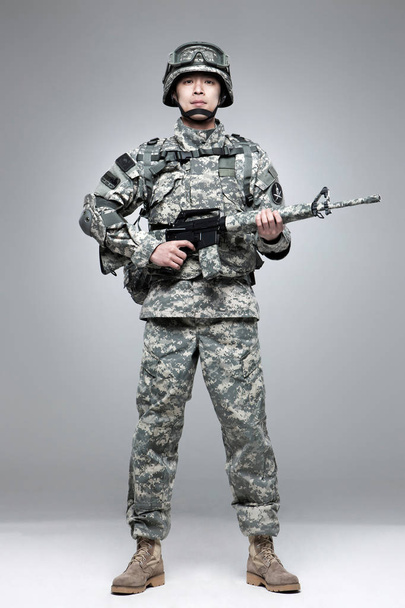 Armed soldier holding a rifle. - Fotó, kép