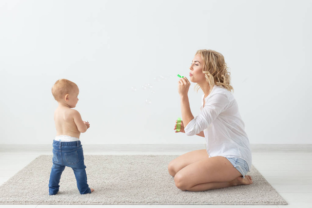 Cute single mother and kid girl playing together indoor at home - Photo, Image