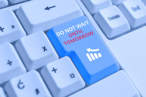 Conceptual hand writing showing Do Not Wait Until Tomorrow. Business photo text needed to do it right away Urgent Better do now White pc keyboard with note paper above the white background. - Photo, Image