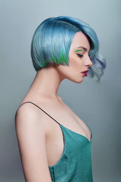 Portrait of a woman with bright colored flying hair, all shades  - Фото, изображение