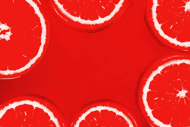 Grapefruits on red background - Fotoğraf, Görsel