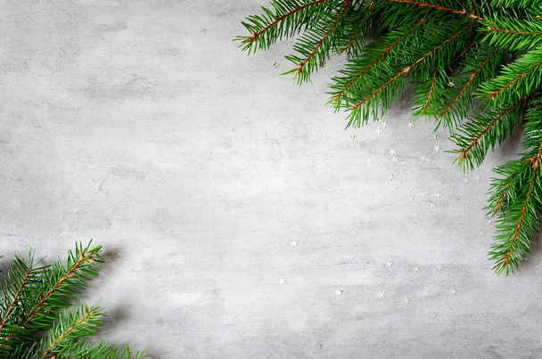 fir branches border on gray background, christmas backdrop - Foto, Imagem